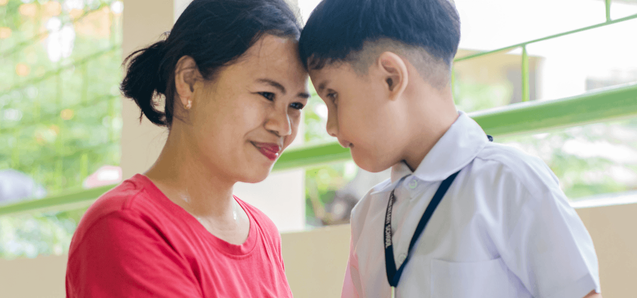Photo: A woman and her child in uniform gaze at each other affectionately.